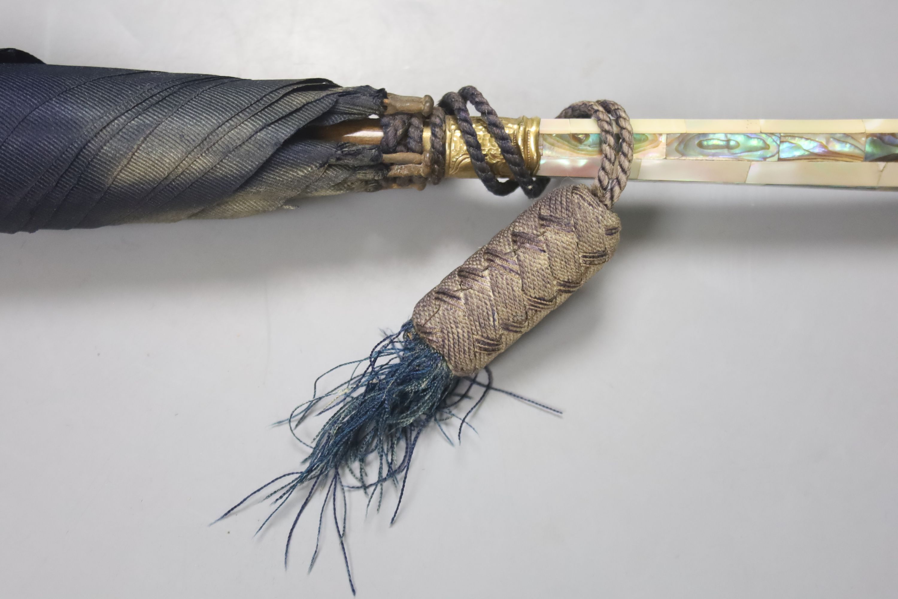 A Victorian umbrella with rosewood mother of pearl and abalone handle